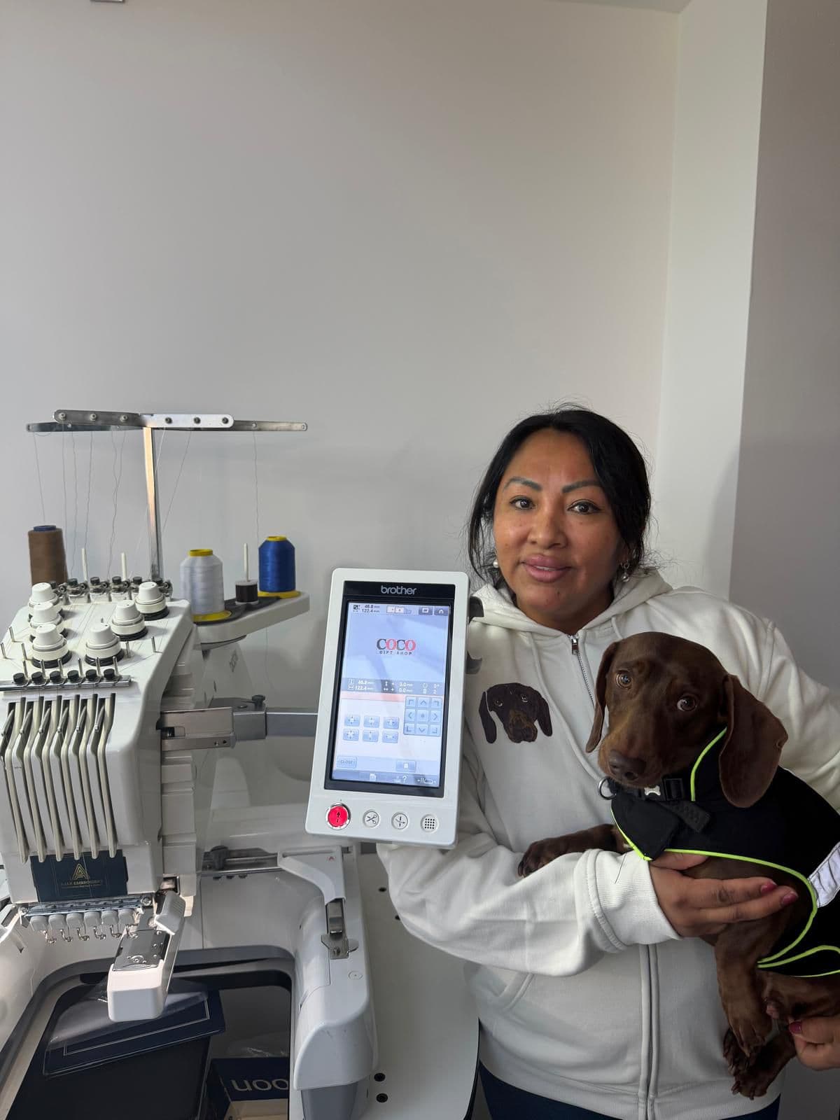 Owners with their pet wearing embroidered hoodie